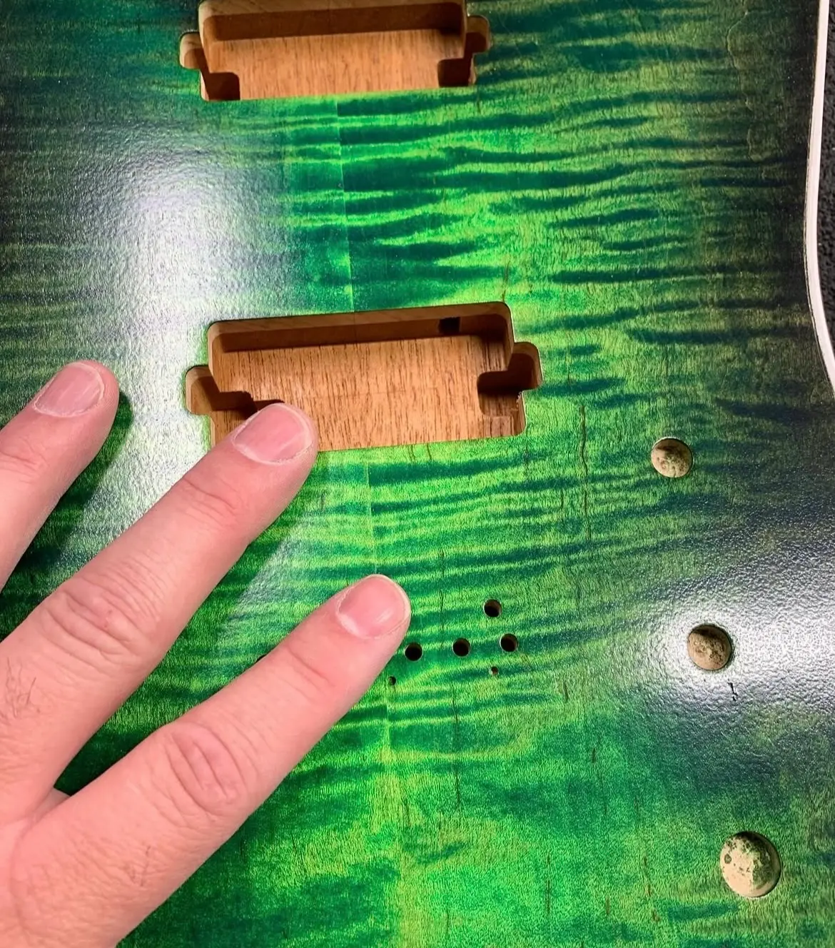 a green stained maple cap guitar body